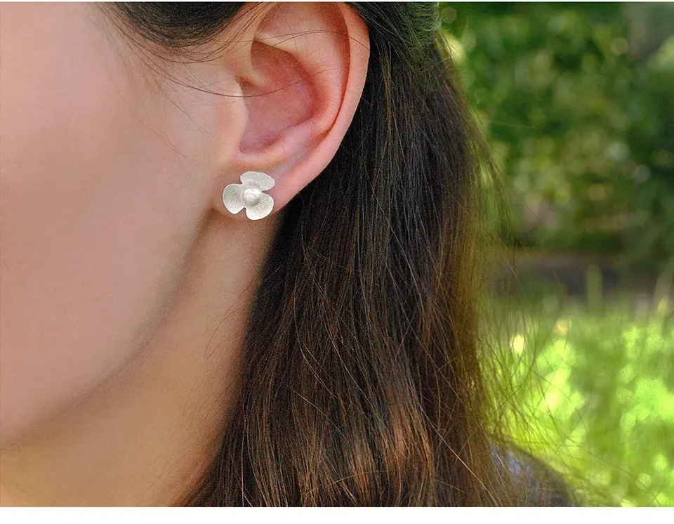 natural pearl silver clover earrings being worn by model